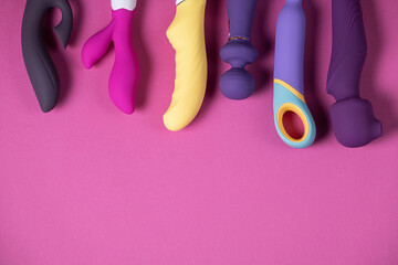 Sex toys. Many vibrators on a bright background. Useful for adult and sex shop