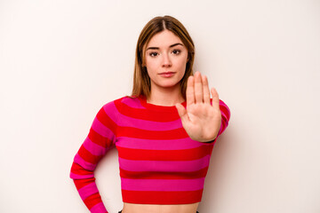 Young caucasian woman isolated on white background standing with outstretched hand showing stop...