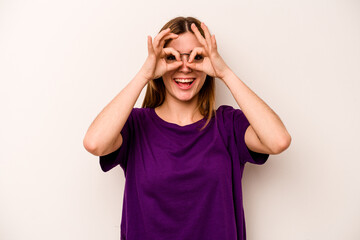 Young caucasian woman isolated on white background excited keeping ok gesture on eye.