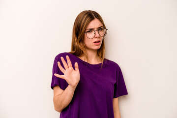 Young caucasian woman isolated on white background rejecting someone showing a gesture of disgust.
