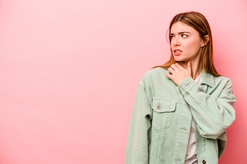 Young caucasian woman isolated on pink background touching back of head, thinking and making a choice.