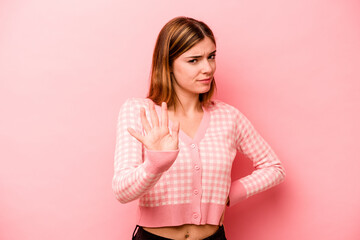 Young caucasian woman isolated on pink background rejecting someone showing a gesture of disgust.