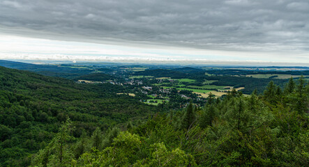 view from hill in valley with small town in forests