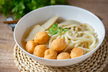 Udon, Shrimp Balls, and Fish Balls in Clear Soup Japanese Cuisine in a white porcelain cup