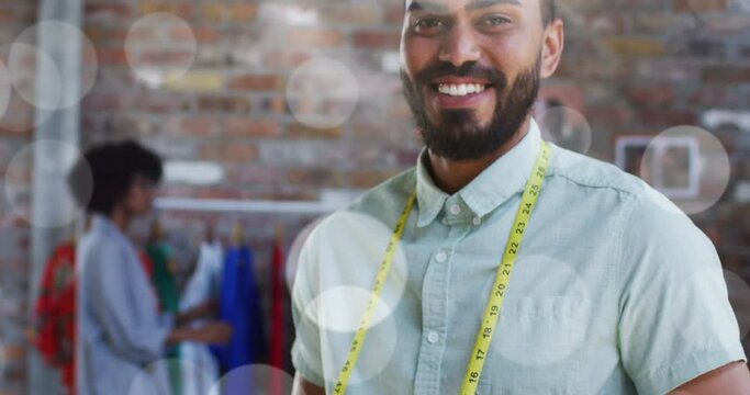 Video of spots of lights over biracial male tailor