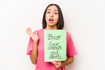 Young hispanic woman holding bio placard isolated on white background surprised and shocked.