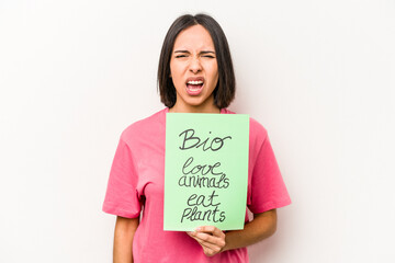 Young hispanic woman holding bio placard isolated on white background screaming very angry and aggressive.