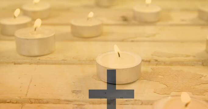 Video of black crucifix shape over burning tealights