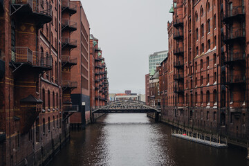 Warehouse district of Hamburg, bridge among architecture, cityscape.