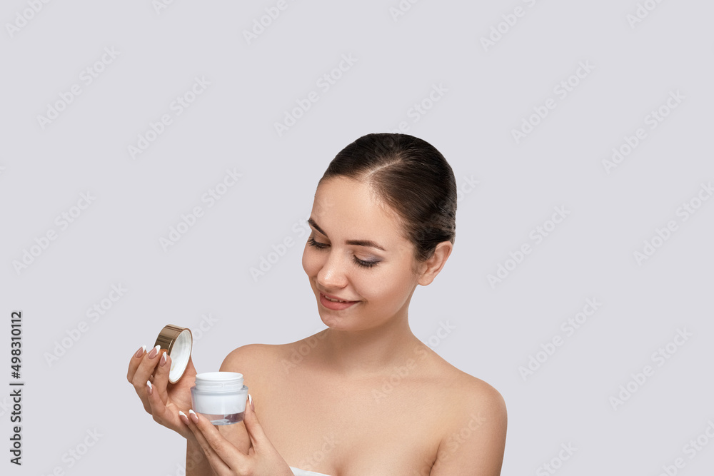 Canvas Prints Skin care. Beauty Concept. Young woman holding cosmetic moisturizing cream.  Dermatology.