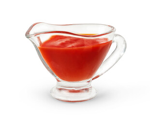 Glass sauce boat with ketchup isolated on white background.