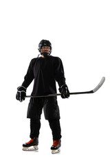 Full-length portrait of professional hockey player in special protective unifrom posing with stick isolated over white studio background