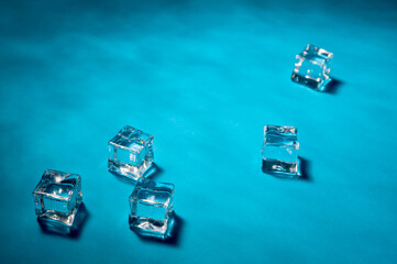 Clear ice cubes for cooling drinks on a blue background.