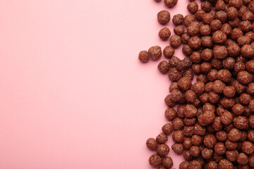 Chocolate cereal corn balls on a pink background.