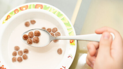 chocolate cereal ball in milk for breakfast