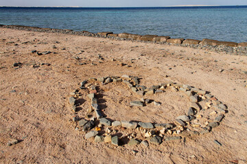 a heart-shaped stone figure on the seashore