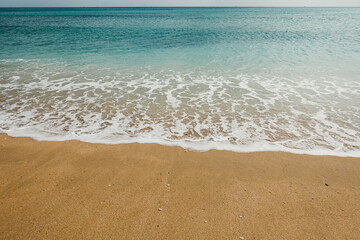 Low angle shot of sea wave foam and turquoise water