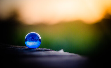 Blue sphere with inner light on the edge of the cliff