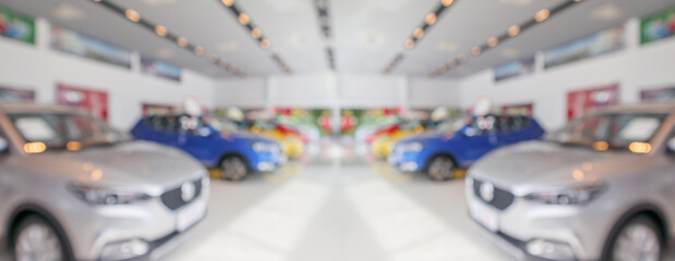 new cars in showroom interior blurred abstract background - obrazy, fototapety, plakaty