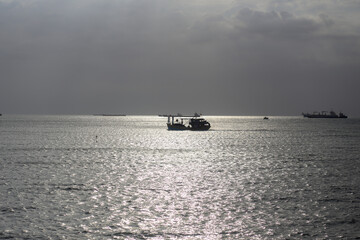 View of the fishing boat under sunlight on the sea in Vung Tau City