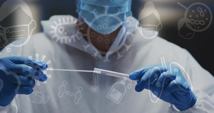 Animation of medical icons over caucasian male doctor wearing face mask