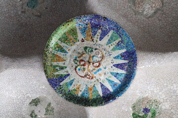Naklejka premium mosaic in the park guell, Broken multicolored glass background texture, ceramic tile in park Guell, Barcelona, Spain