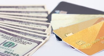 dollar bills and bank cards. Counterbalance of money to bank and credit cards