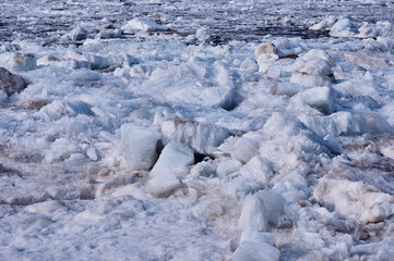 Melting river ice. Columnar and needle-like structure of crystals. Ice floe in the spring on the banks of the Amur River.