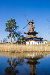 Historic windmill reflecting in the water in Gifhorn, Germany