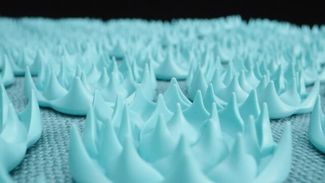 Massage blue mat with acupuncture needles. Dolly slider, rotation. Macro video. Laowa Probe