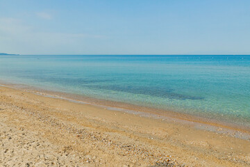 Fototapeta na wymiar Beautiful view of sea sand beach with turquoise water on island Greece.