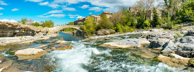 The river Orbieu flowing through the pretty village of Ribaute in the South of France.