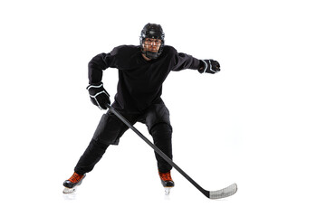 Active player. Professional hockey sportsman in special uniform training, practising isolated over white studio background