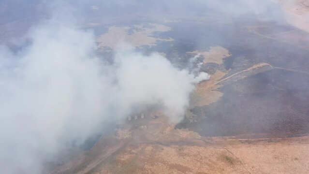 Aerial view of firefighters attempting to control a large grassfire