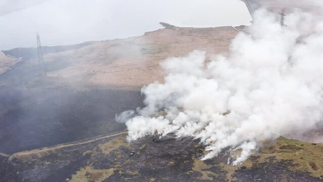 Aerial view of firefighters attempting to control a large grassfire