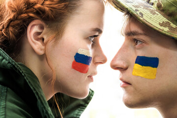 Woman and a man looking at each other with national flags of Ukraine and Russia