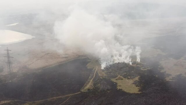Aerial view of firefighters attempting to control a large grassfire