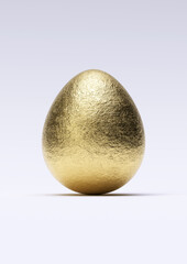 Chocolate easter egg with shiny gold foil on white background. Close-up.