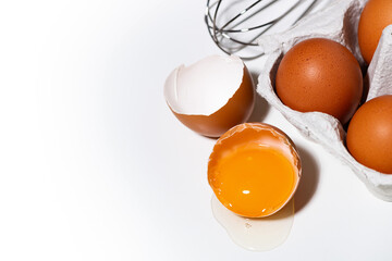 broken chicken egg on white background, baking ingredients, top view