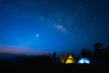 Fototapeta na wymiar milky way with meteor star and hiking tent in summer time