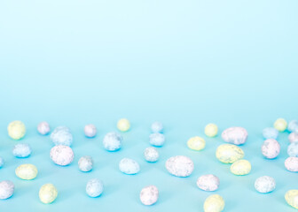 Easter concept. Multicolored pastel eggs on a blue background. 