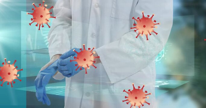 Animation of no entry sign over virus cells and male doctor putting gloves on