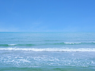 The sea with slight waves against the sky background