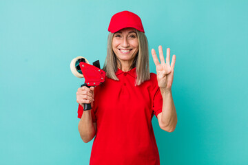 senior gray hair woman smiling and looking friendly, showing number four. packer employee concept