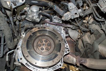 View of a two-mass (damper) flywheel in the engine compartment of a car with the gearbox removed