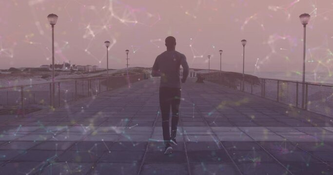 Animation of moving shapes over african american man running on promenade