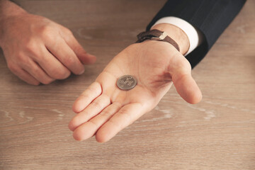 businessman hand holding coins putting in jar concept finance and accounting saving