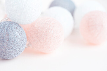 Holiday concept. Illumination from balls with threads. Jewelry and accessories. Birthday. Pastel shades