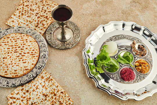 Passover Seder plate with traditional food ontravertine stone background