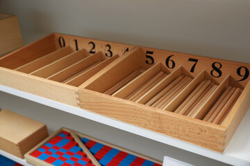 White shelving unit with different montessori toys